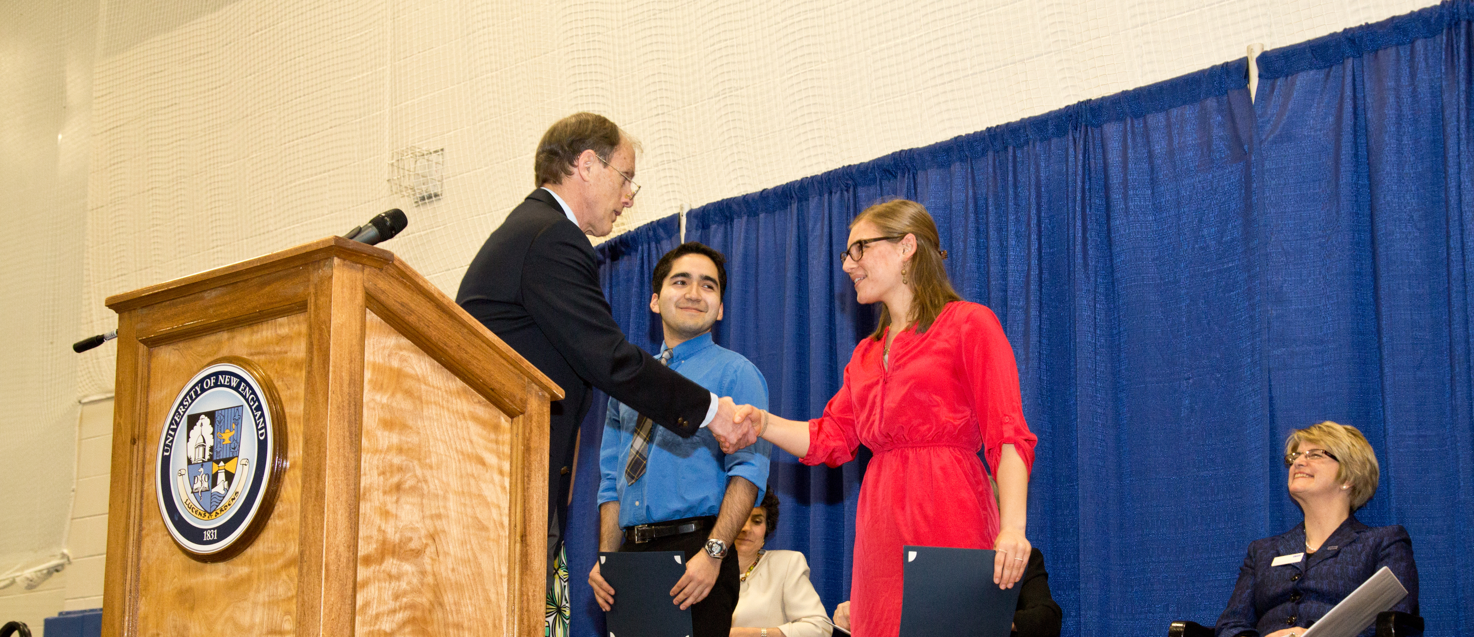 Student shaking hands biddeford awards ceremony