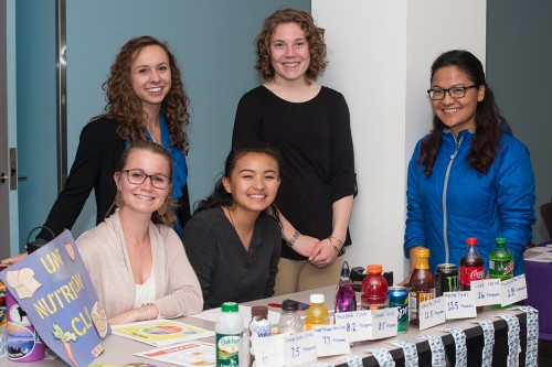 Nutrition students have a table of at a U N E health fair