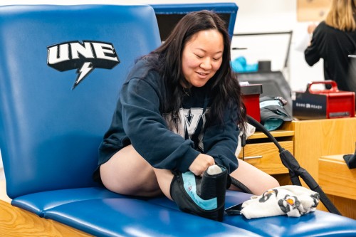 A student practices ice wrapping their leg in an athletic training lab