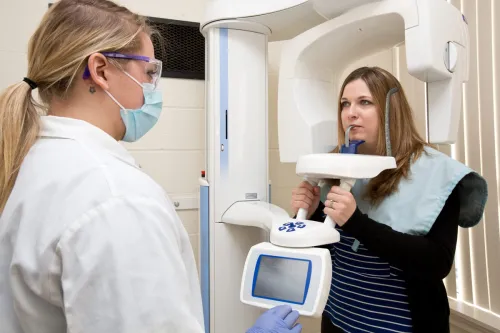 A dental hygiene student takes dental x-rays of a patient