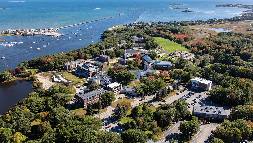 Aerial photo of U N E's Biddeford campus including buildings and the ocean