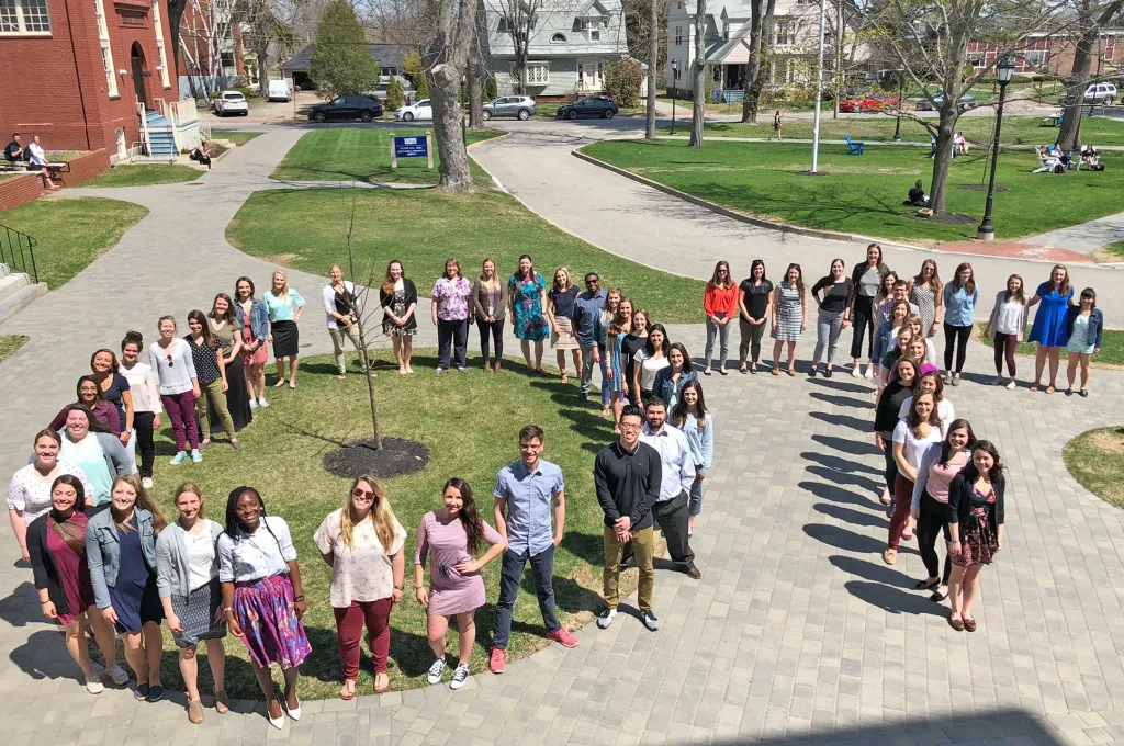 occupational therapy master's class of 2018 students stand in OT shape