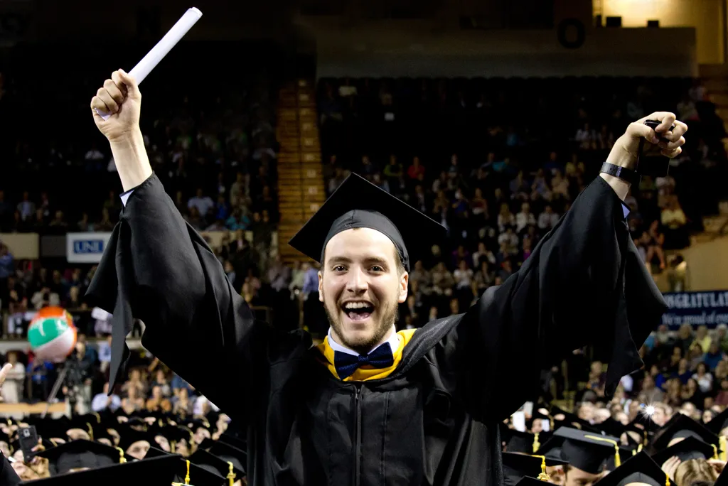 Graduating student holding diploma