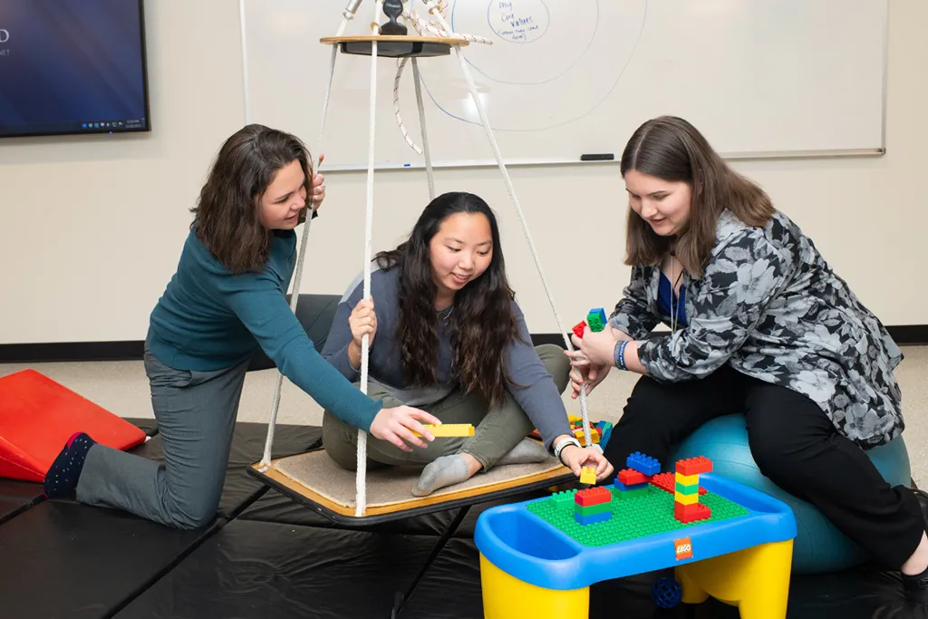 U N E occupational therapy students work with a patient