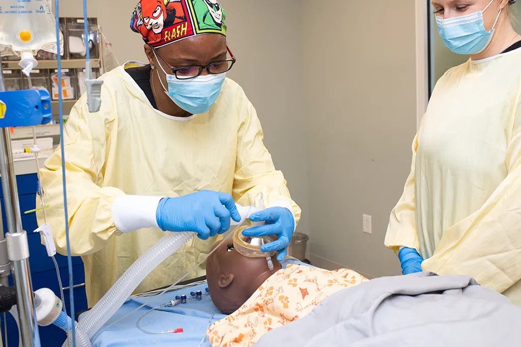 A U N E D N P student practices on a patient simulator