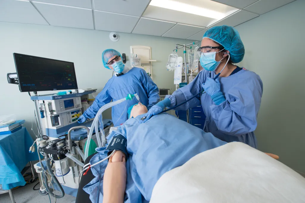 Image of nursing students tending to simulation patient