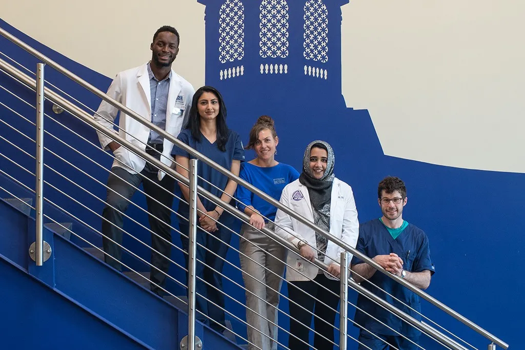 A group of health students standing on the staircase in Innovation Hall