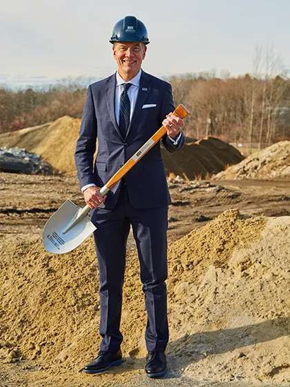 UNE President James Herbert poses with a shovel at the groundbreaking