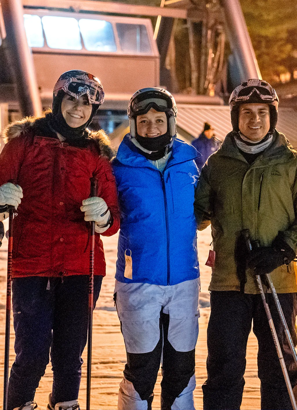 Three U N E students taking a photo on a snowy mountain during a ski trip