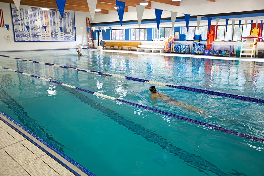 A U N E student swims in the Campus Center pool