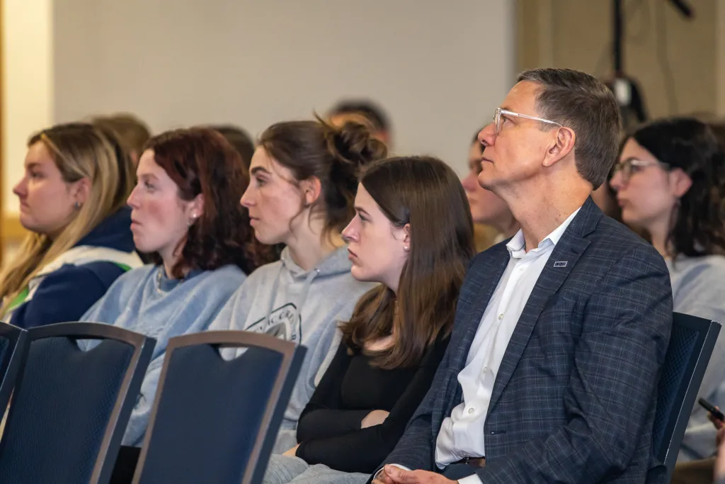 UNE President James Herbert watches in the crowd