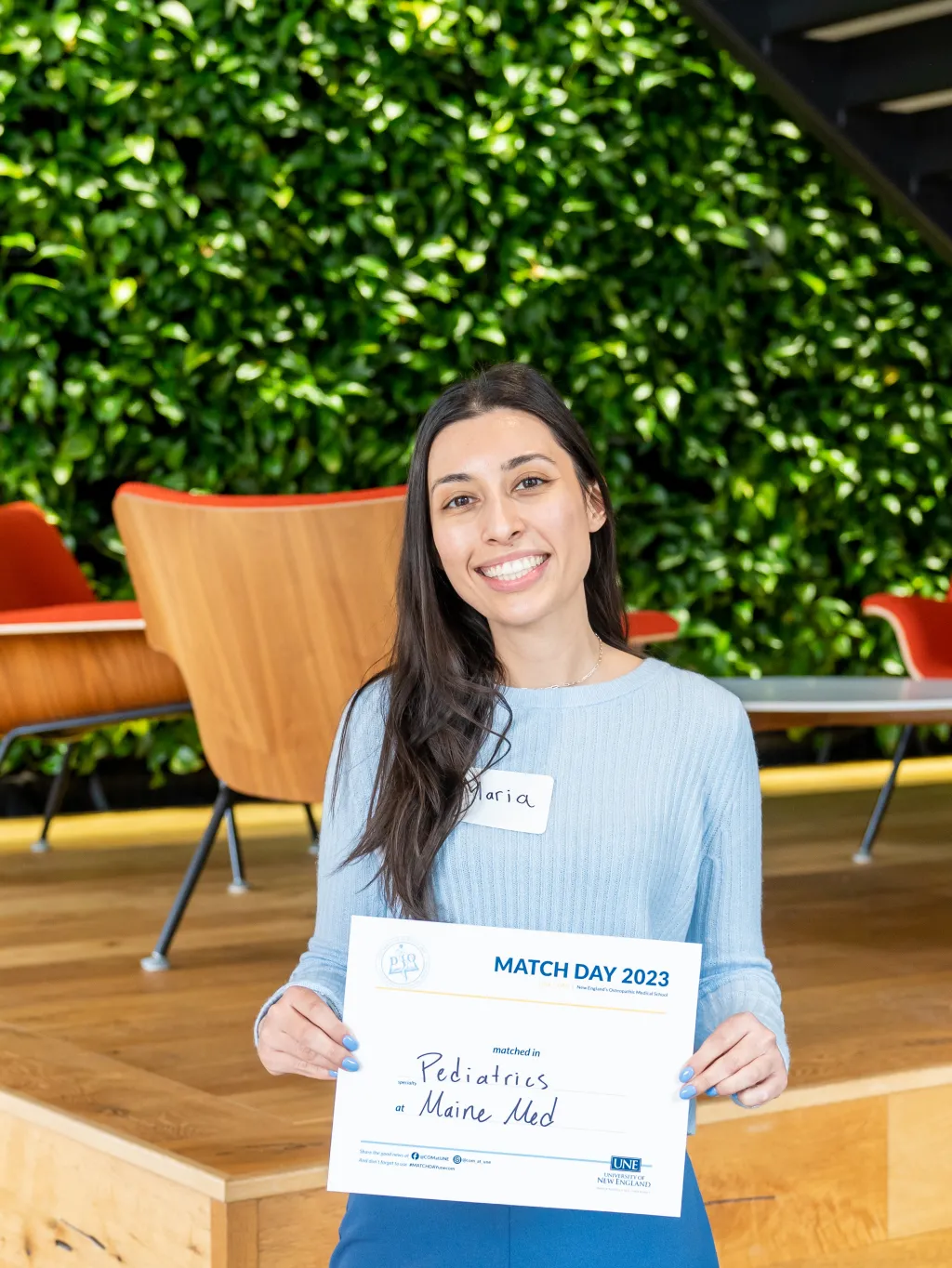 Maria Terzis (D.O., ’23) poses with a paper listing her residency match 