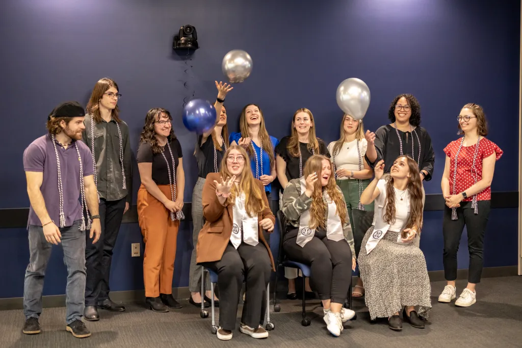 A group of students plays with balloons