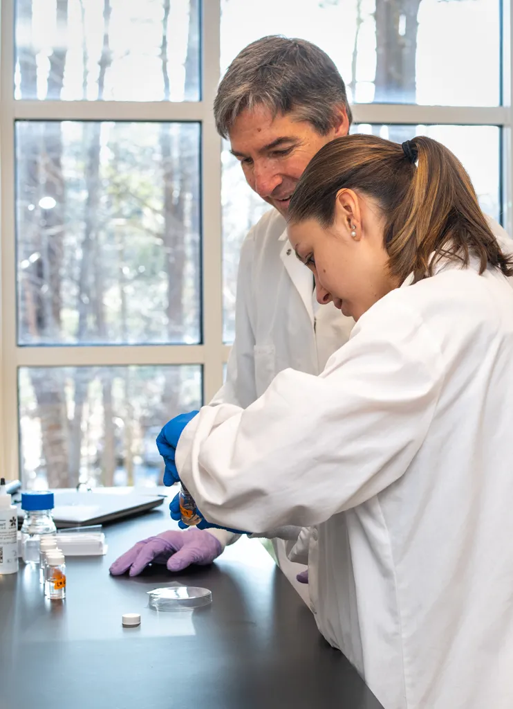 A student works with a professor on research