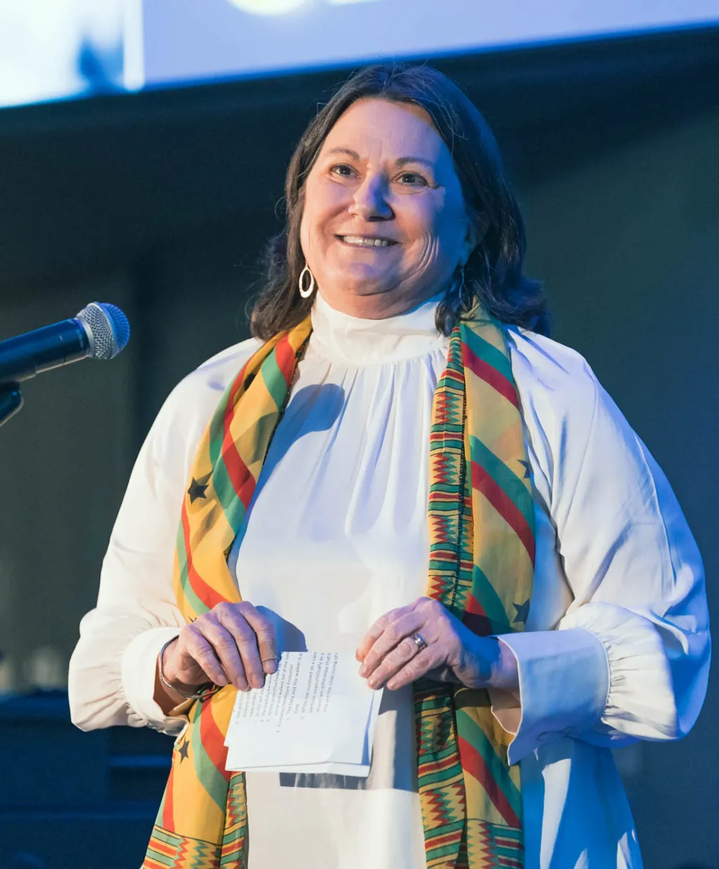 woman on stage with scarf on from Ghana