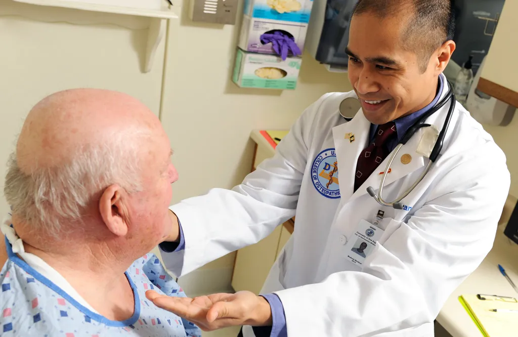 A D O student performs an exam on a patient