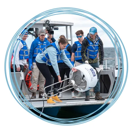 A group of Marine Science students deploy a shark detection buoy into the Atlantic Ocean