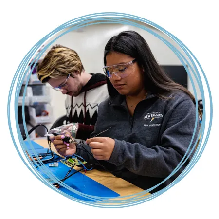 Two students soldering in the Makerspace