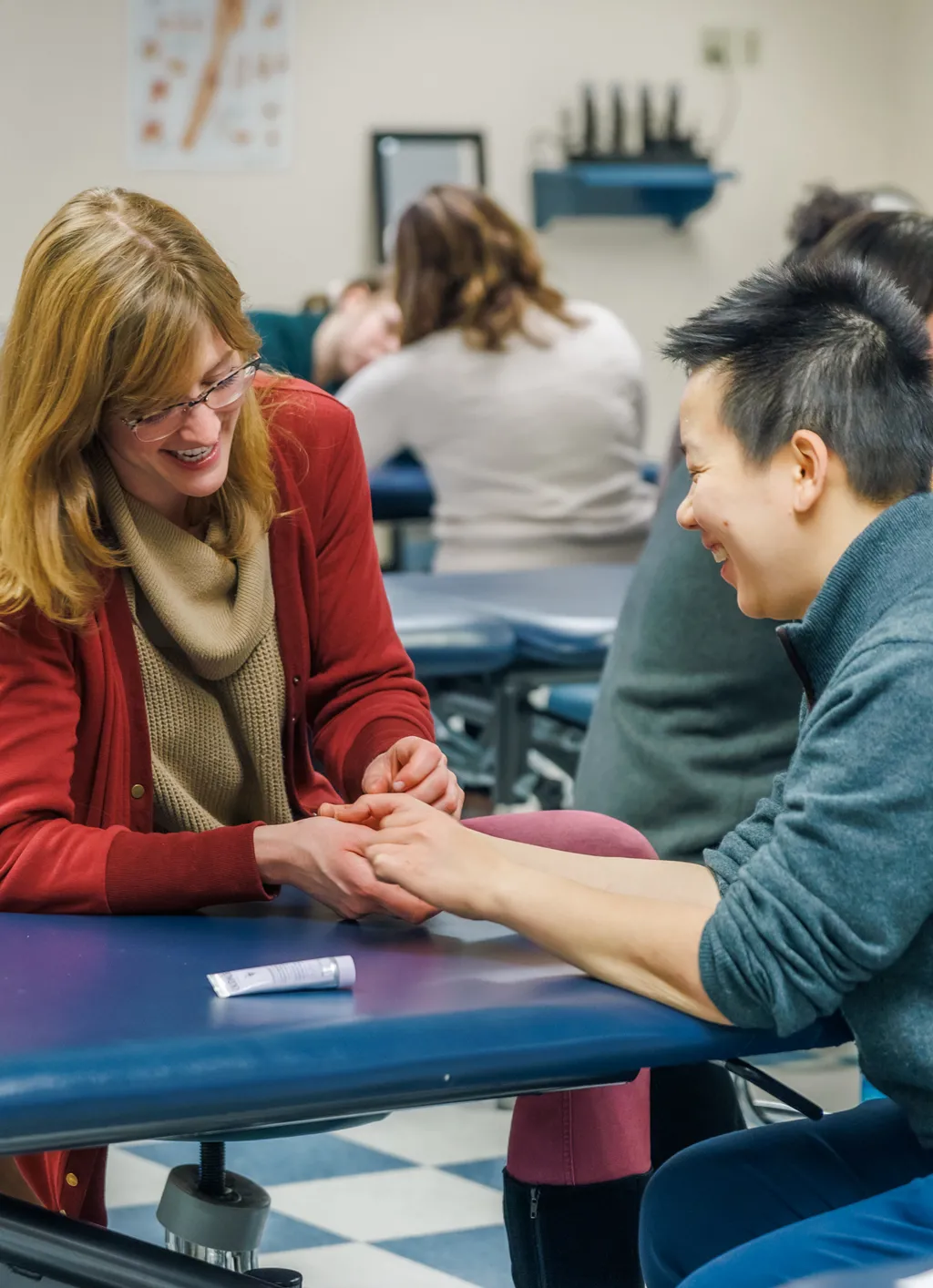 Two D P T students practice hand therapy in class