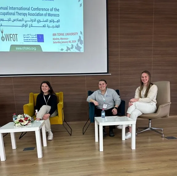 Three OT students participate in a panel discussion onstage