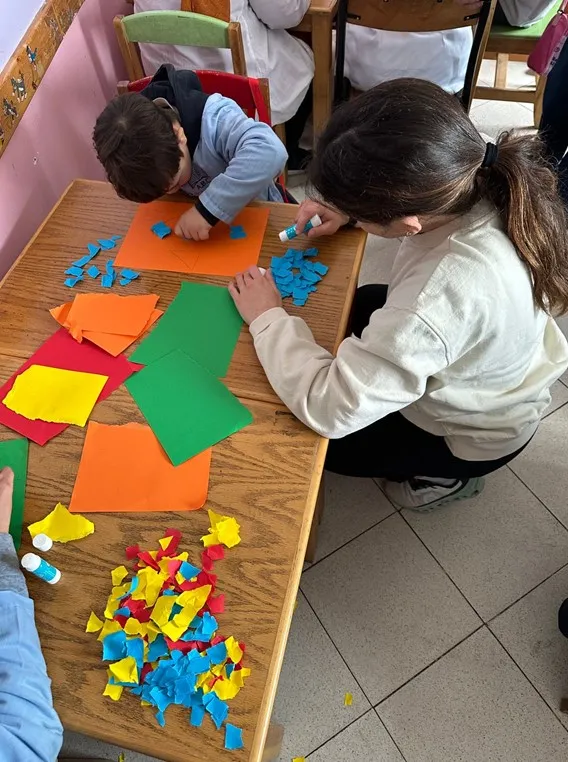 A student works with a child at The Brotherhood