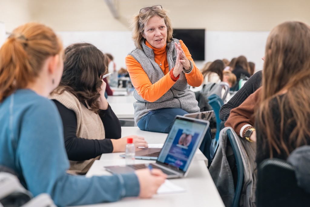 Group of U N E nursing students listen to the professor during class