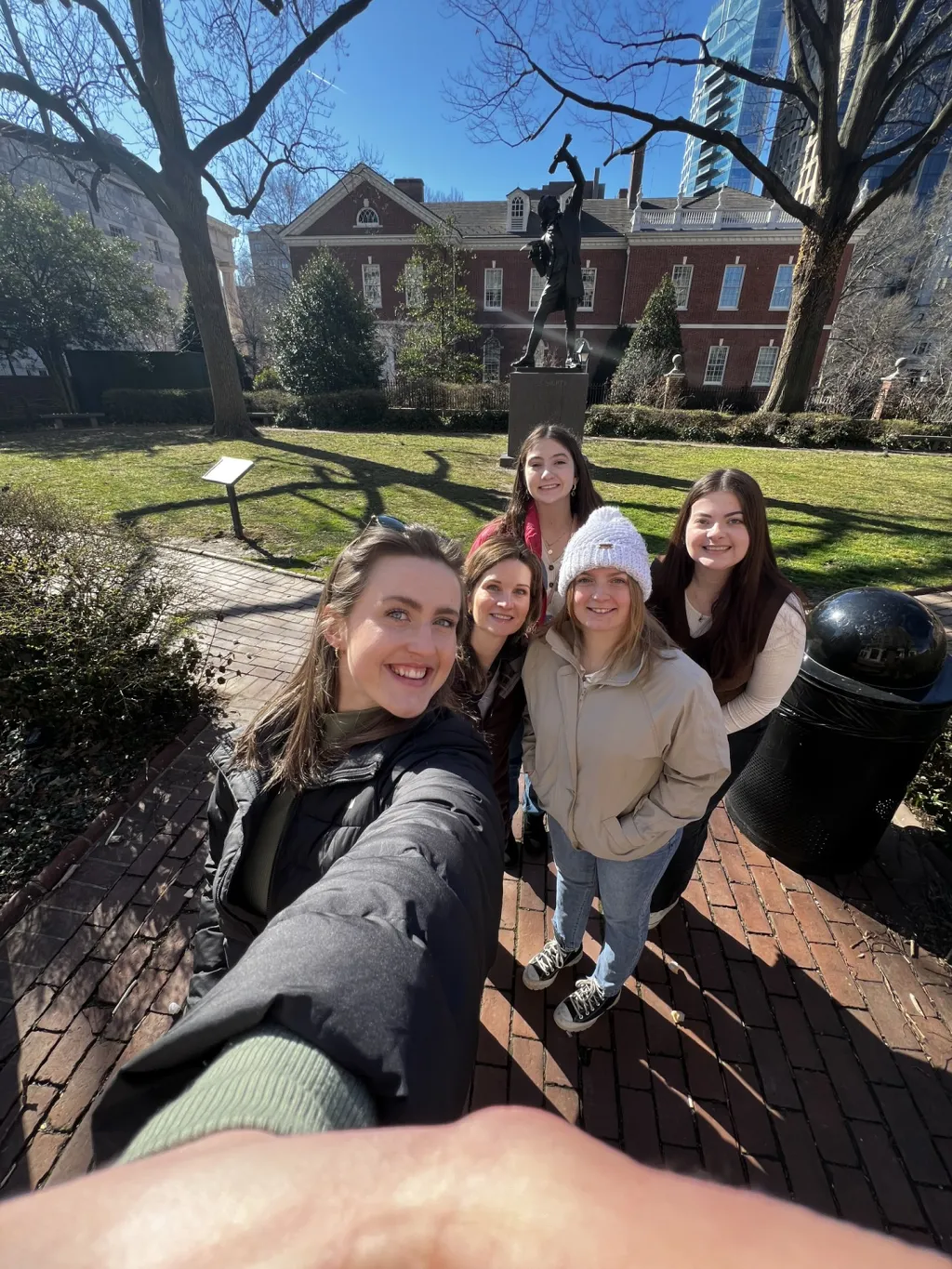 A group of UNE students and faculty take a selfie in front of Philadelphia's Independence Hall