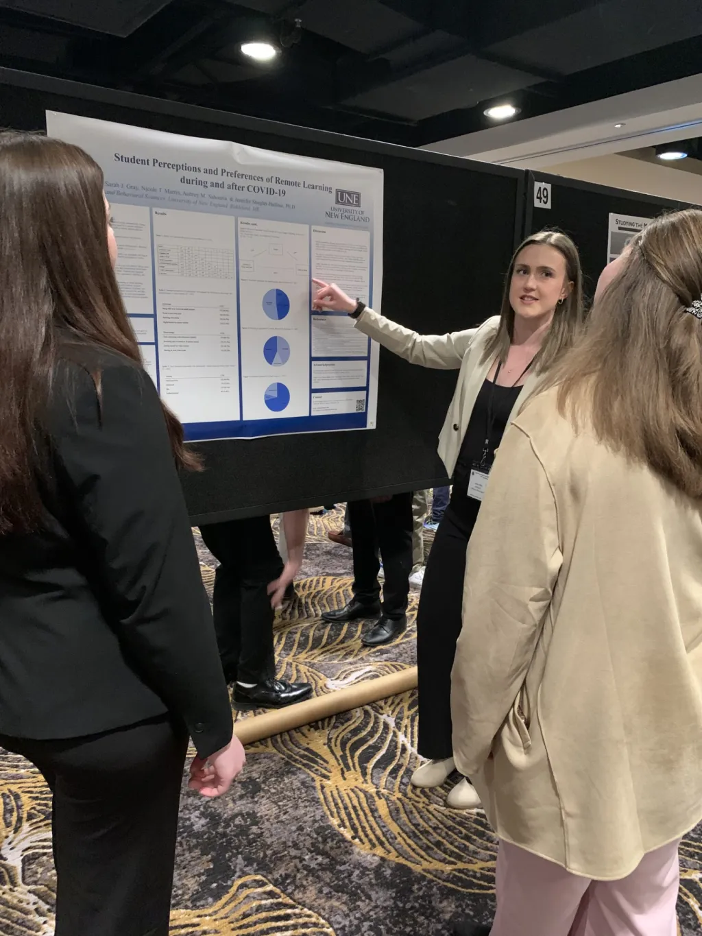 A female student presents her research poster