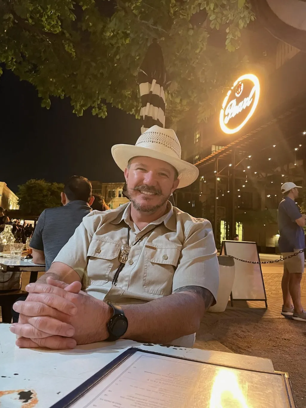 Oak McCoy sits at a restaurant table 