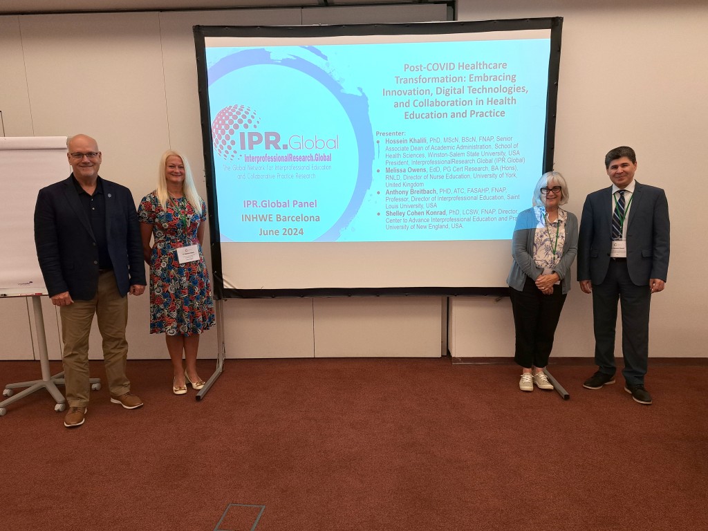 Four researchers pose in front of a slideshow bearing their names