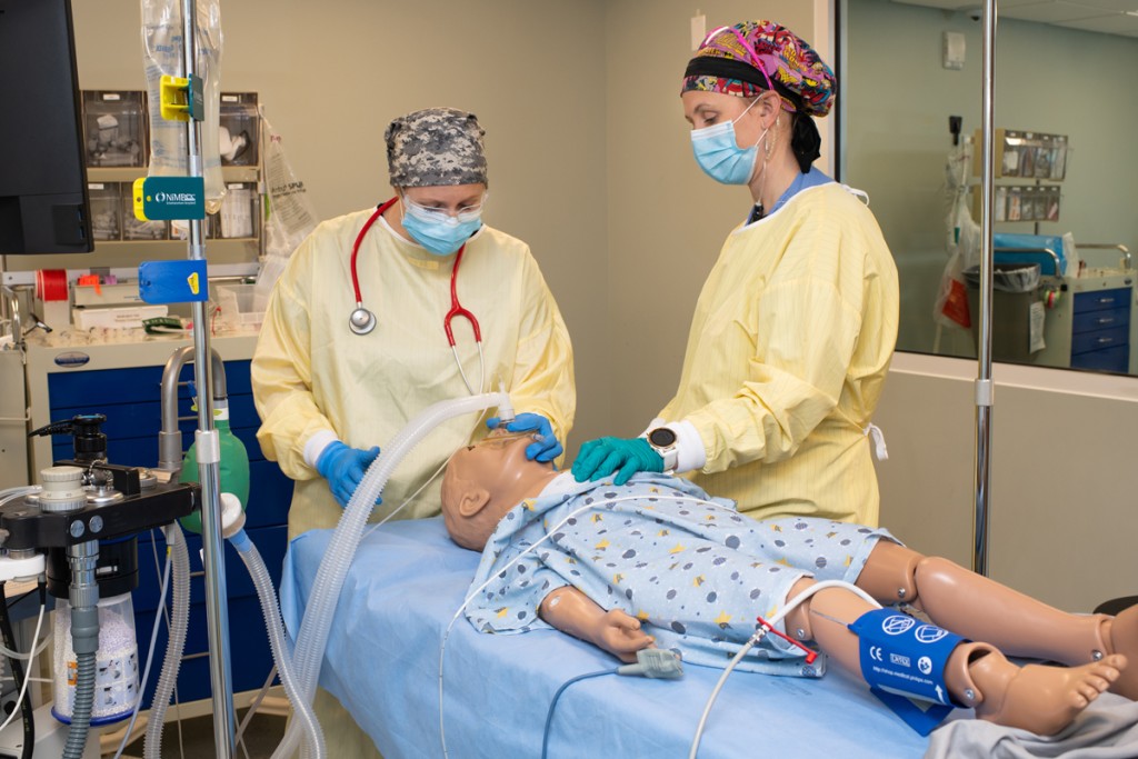 Two U N E Nursing Anesthesia students practice giving a simulation dummy anesthesia