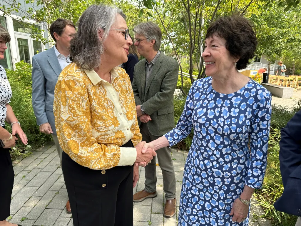 Karen Houseknecht and Sen. Susan Collins shake hands