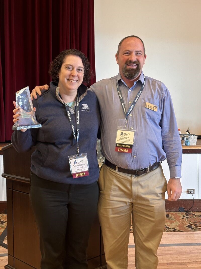 Villmore poses with her award and UNE's Christopher Bates-Withers