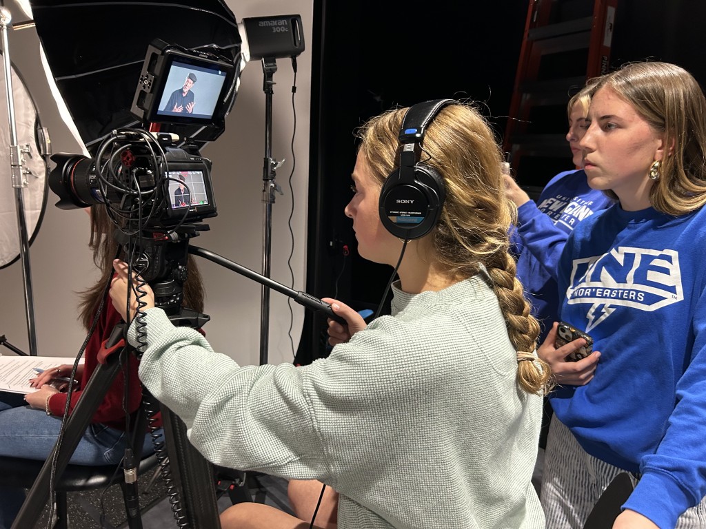 Three female students operate equipment in UNE's Production Studio