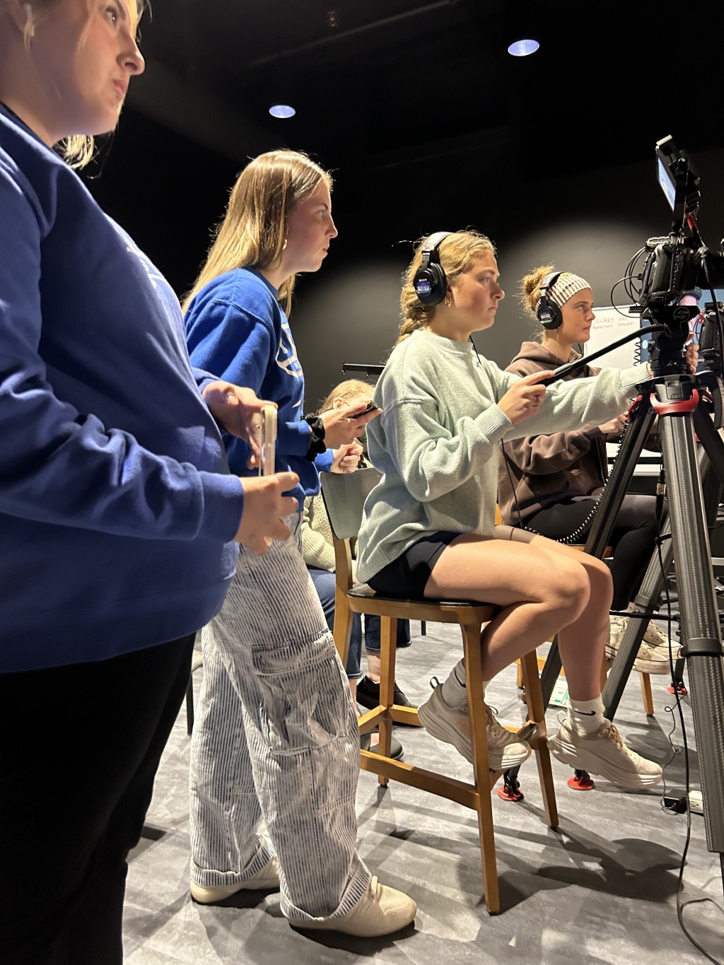 Three female students operate equipment in UNE's Production Studio