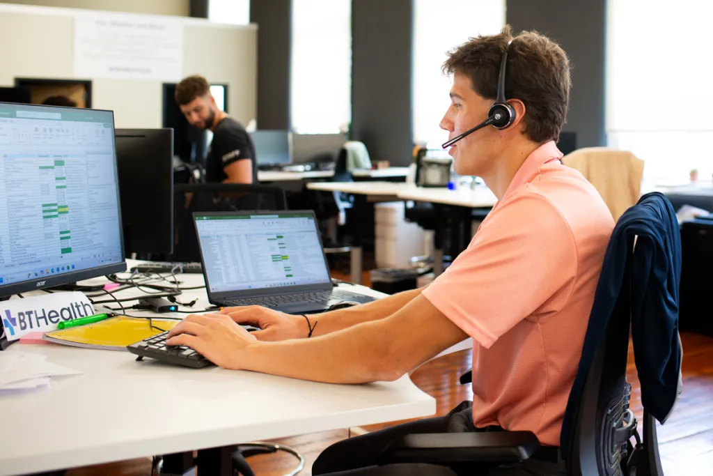 A Business Administration student sits in an office setting for his sales internship