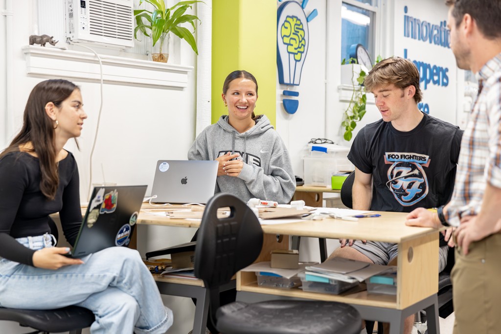 A group of students discuss a prototype that will encourage more people to get outdoors in Maine.