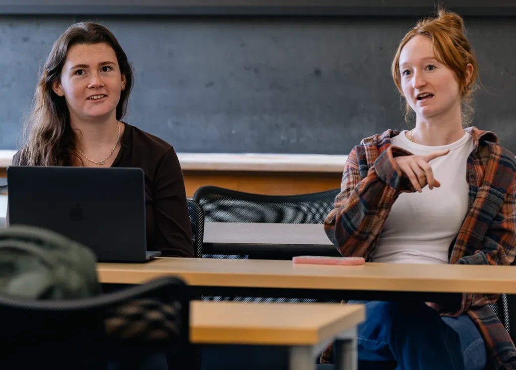 Two M S W students talk in a classroom