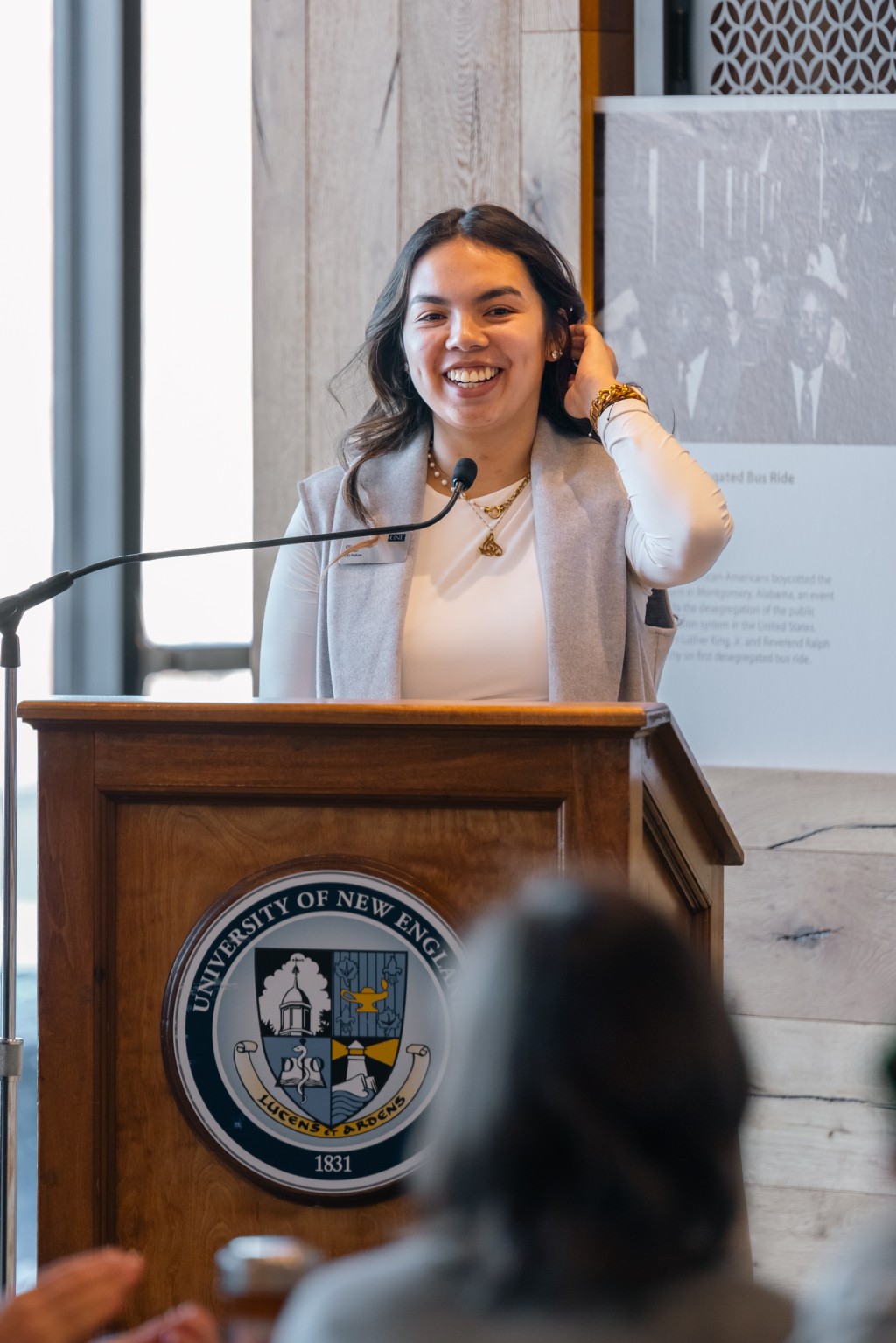 Student speaker Olivia Lu-Alba speaks at the podium