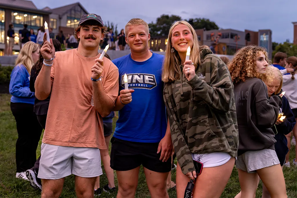 A group of undergraduate students hold fake candles for the First Night event on Biddeford campus