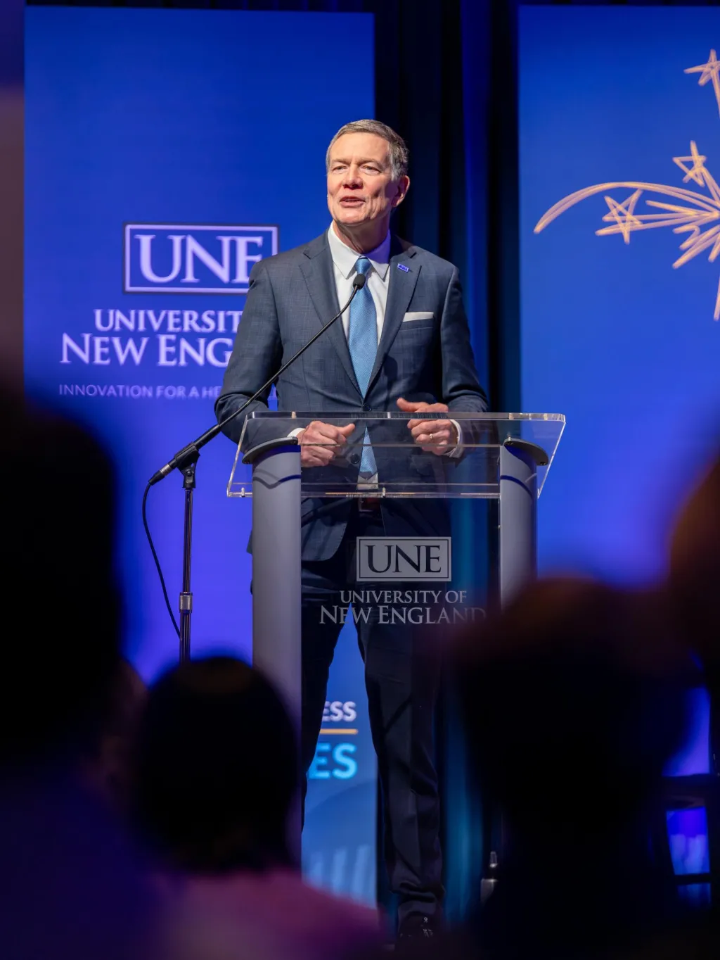 UNE President James Herbert speaks at the podium