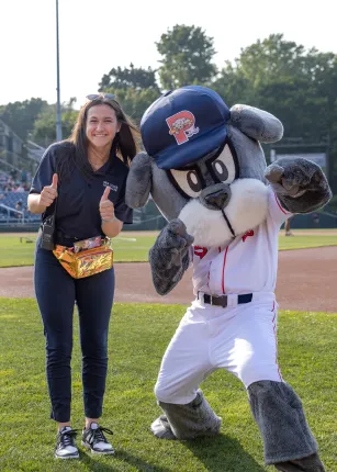 White poses with Slugger the mascot