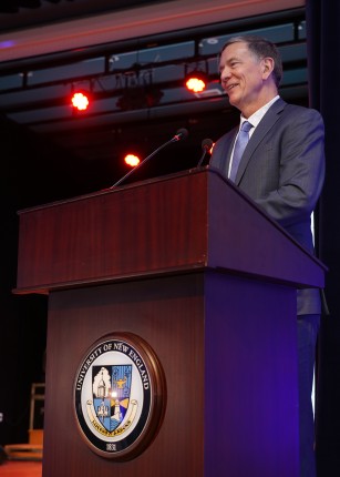 UNE President James Herbert speaks at the podium