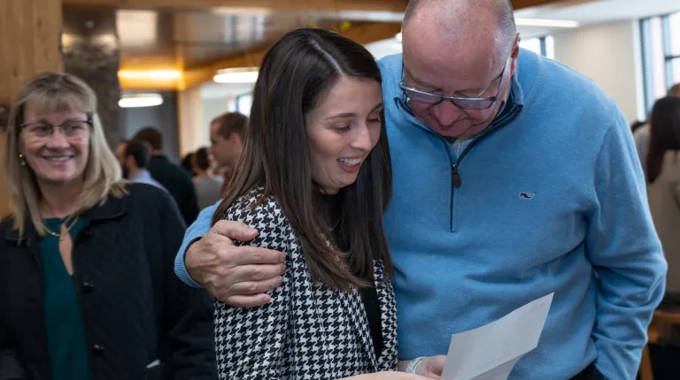 A student celebrates her match with a family member