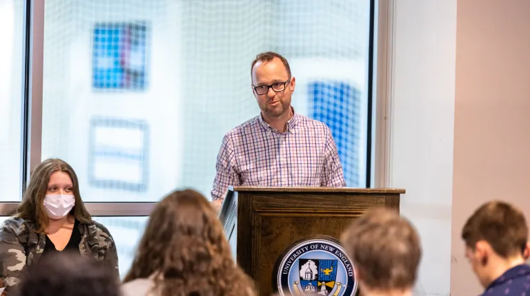 Mike Burman speaks at a podium