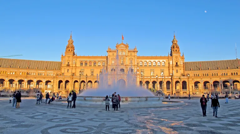 A view of the architecture and a water fountain in Plaza de Espana