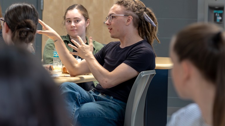 Student asks a question during a panel discussion.