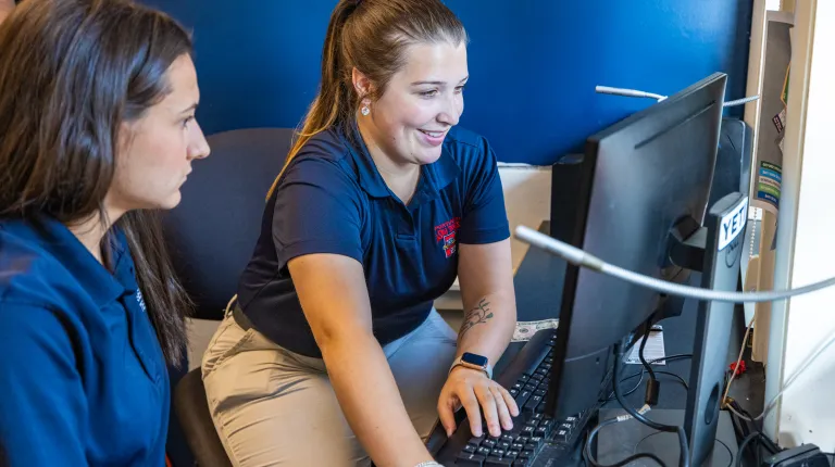 Fickett and White oversee ticket operations at the computer