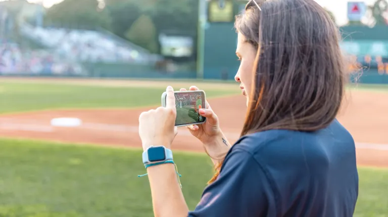 White films Slugger on her phone for social media