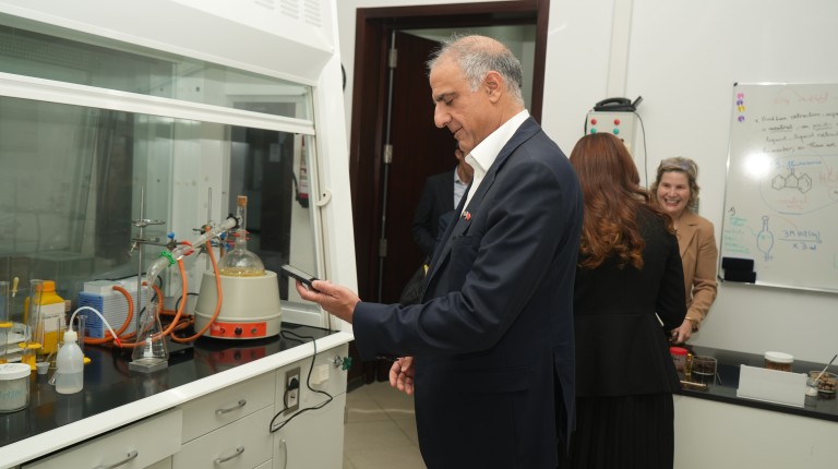 Ambassador Talwar examines UNE's laboratory facilities and equipment